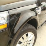 Before and after photographs of a damaged, black, Range Rover that was repaired by Elite Paint & Body Shop in West Palm Beach, FL.